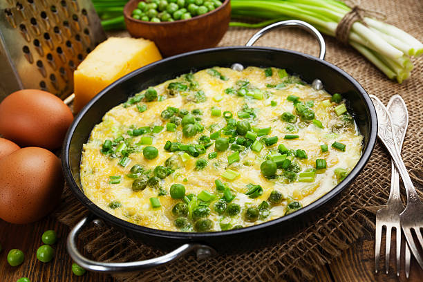 Omelette with green peas, potatoes and cheese stock photo