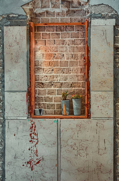 istock Window sealed with red bricks in an abandoned building 505377848