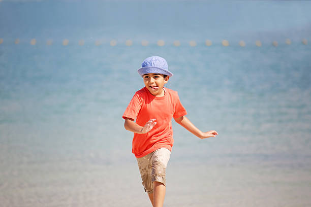 istock Boy running by the sea 505378392