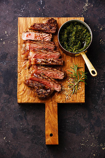 istock Sliced grilled beef Sirloin steak with chimichurri sauce 505381410
