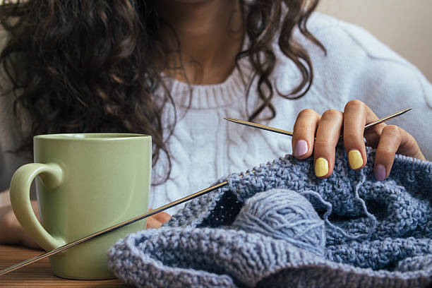 istock The girl, knitting and green cup 505381540