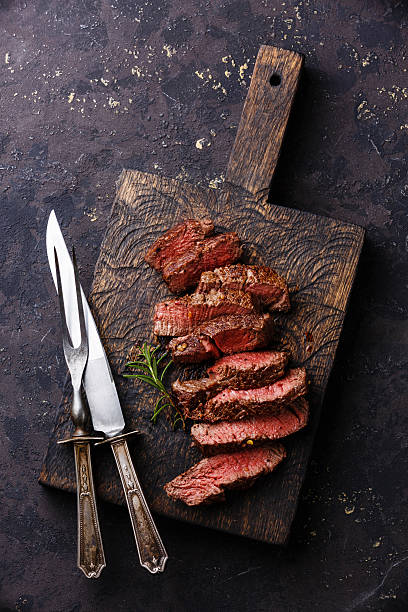 Sliced steak with knife and fork for meat