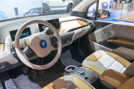 Brussels, Belgium - Januari 12, 2016: Interior of a BMW i3 five-door urban electric car. The minimalistic interior is fitted with light fabric seats, a wood panel and two information displays on the dashboard. The car is on display during the 2016 Brussels Motor Show. 