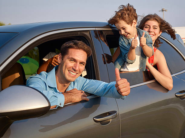 istock Happy family leaning out car windows 505382496