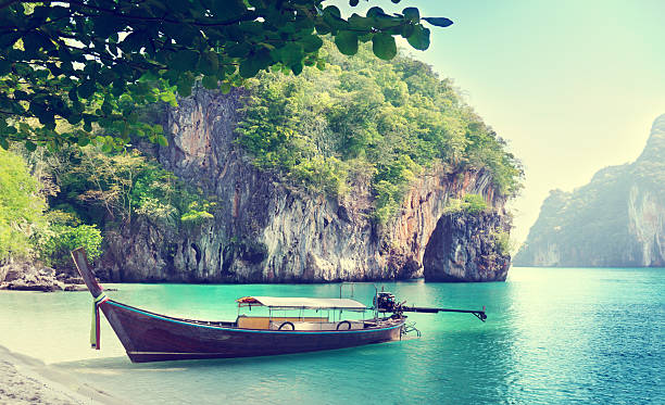 istock long boat on island in Thailand 505394773