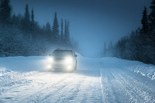 istock Car lights in winter Russian forest 505394967