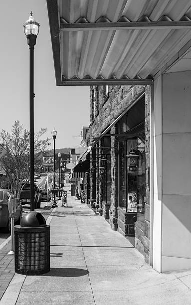 Small Town USA Photo taken of the view down the sidewalk, of Clinton, Tn, All names removed.  Black and white, Small town USA small town photos stock pictures, royalty-free photos & images