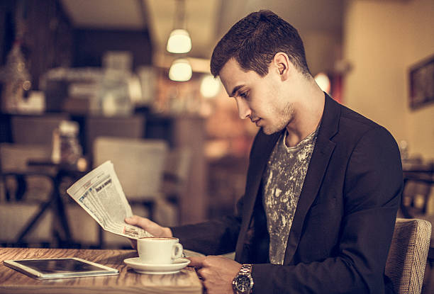 istock young businessman reading a newspaper 505397736