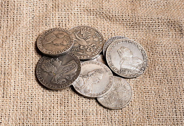 istock Some silver Russian Empire coins on a burlap canvas 505397968