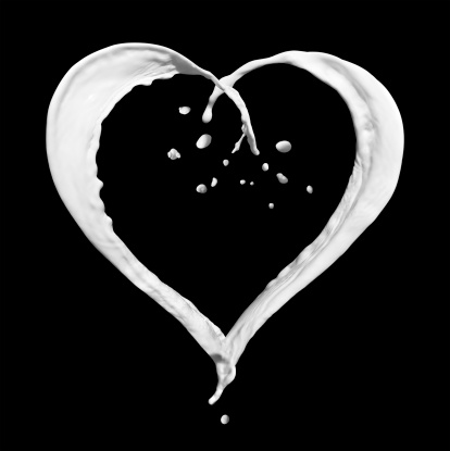 Heart made of milk splashes, isolated on black