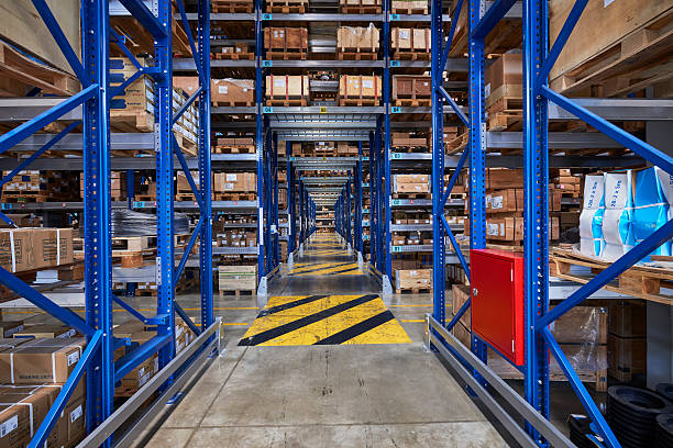 istock Cardboard boxes on shelves in warehouse corridor 505399422