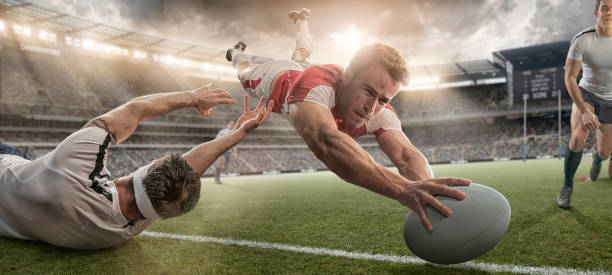 istock Rugby Player Scoring and Being Tackled in Mid Air Dive 505402328