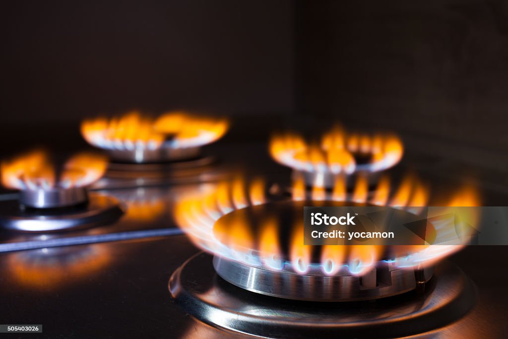 Orange flame at gas stove Gas burning in the burner of gas oven Natural Gas Stock Photo