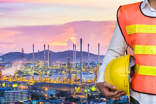 engineer with safty helmet in front of Oil refinery stock photo