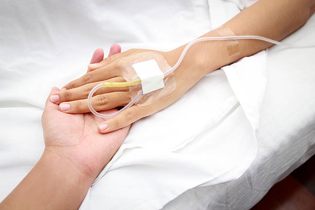 patient in hospital with saline intravenous (iv) stock photo