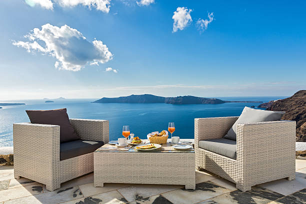 Fresh juice and Breakfast on the sea Fresh juice and Breakfast on the shore of the blue sea, Greece, Santorini. table ledge stock pictures, royalty-free photos & images