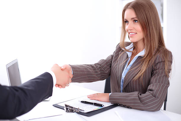 istock young business woman handshaking 505406204