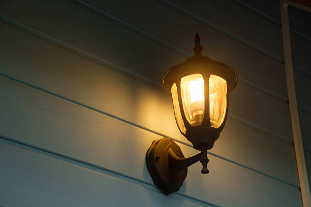 istock Warm light of external lamps on the house wall 505408320