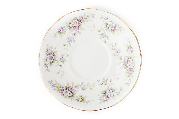 istock Old porcelain plate on the white background 505408350
