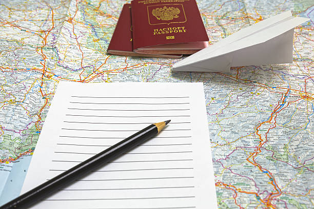 istock Passports, pencil, list, paper airplane on a map 505408436