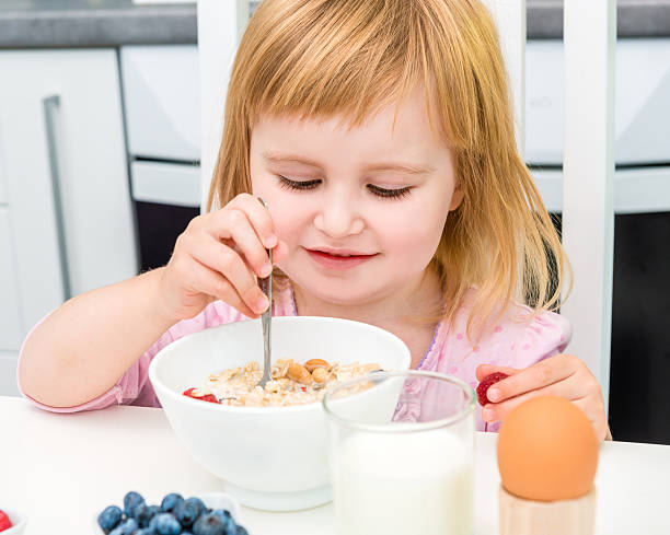istock little girl having healthy breakfast 505408448