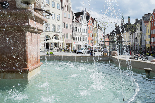 Landsberg, Germany - May 17, 2015: The Marienbrunnen or Mary Fountain at the main square of Landsberg am Lech is located in the center of the old town. The fountain was built in 1700, and equipped with a sculpture of Mary Immaculate from the Tyrolean sculptor Streiter, Landsberg, Germany, Bavaria, Europe.