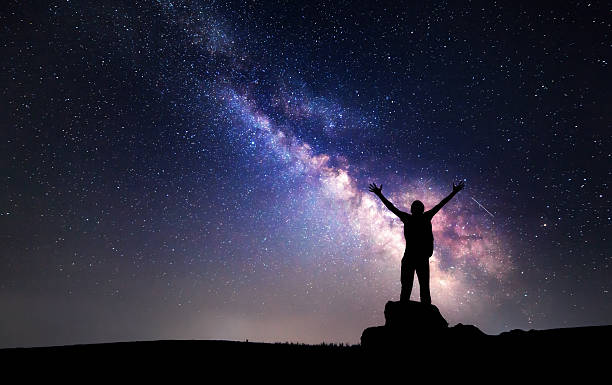 istock Milky Way. Night sky and silhouette of a man 505409816
