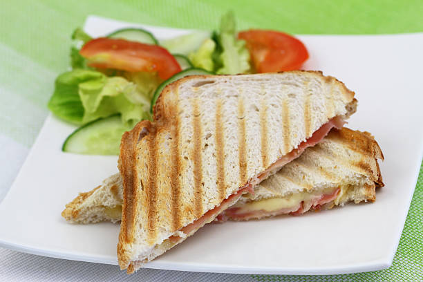 istock Toast with ham and cheese and green salad 505410306