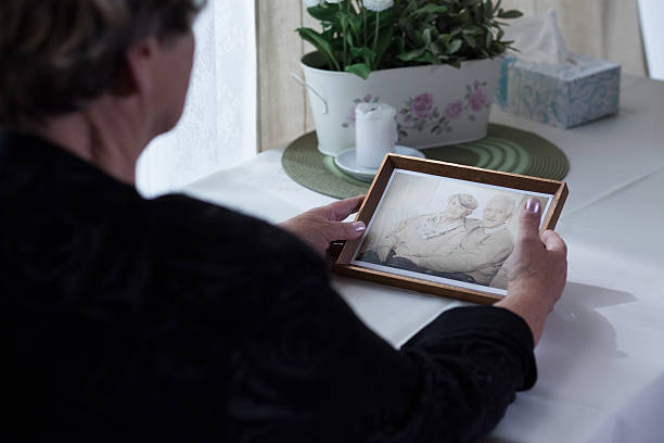 istock Lonely aged female holding photo 505410492