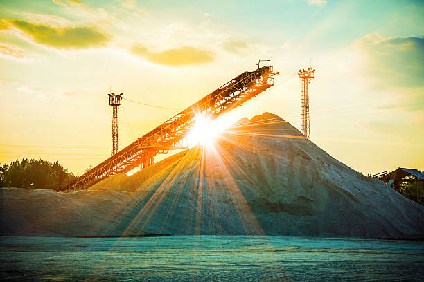 gravel pit gravel pit with an industrial gravel sorter machinery with beautiful sunburst color effect construction truck bulldozer wheel stock pictures, royalty-free photos & images