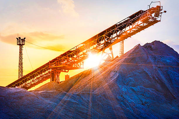 gravel pit gravel pit with an industrial gravel sorter machinery with beautiful sunburst color effect quarry photos stock pictures, royalty-free photos & images