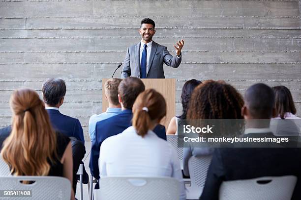 Businessman Addressing Delegates At Conference Stock Photo - Download Image Now - Public Speaker, Speech, Lectern