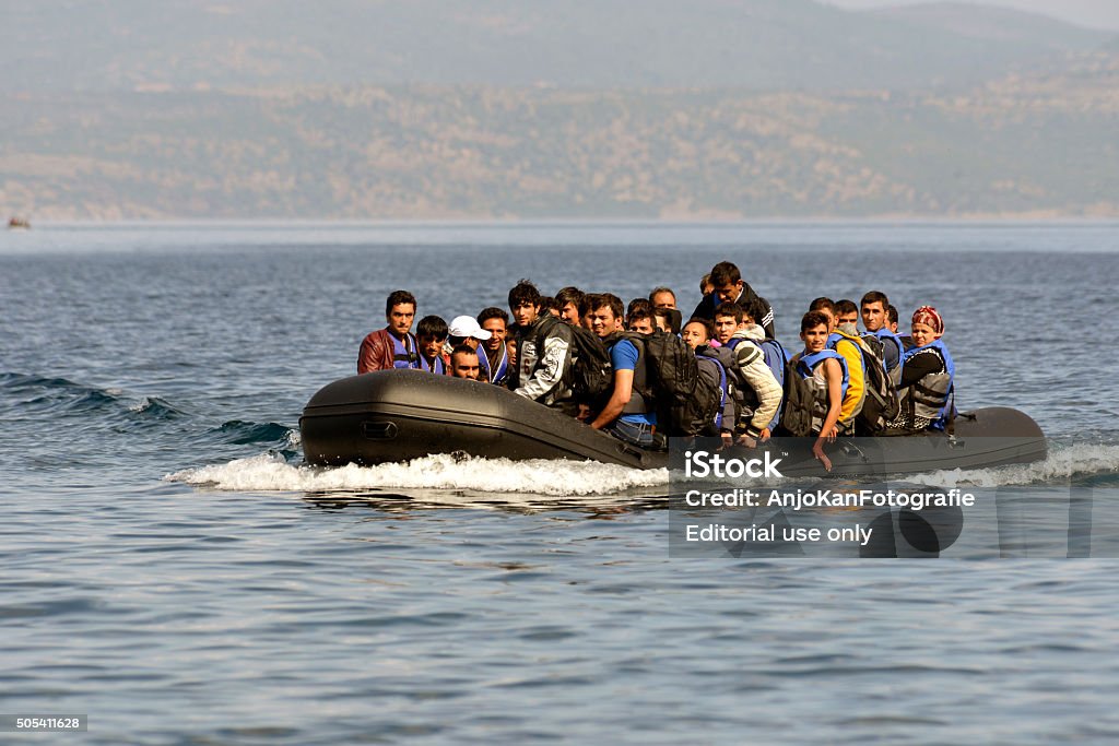 Refugees arrive at Greek island Lesvos Lesvos, Greece- October 12, 2015: Refugees arriving in Greece in dingy boat from Turkey with Syrian, Afghanistan and African refugees .Their boat landed at the North coast of Lesvos near Molyvos, Eftalou and Skala Sikaminia. Immigrant Stock Photo
