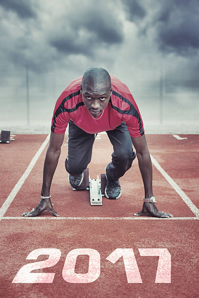 Athlete in the starting blocks Athlete in the starting blocks forward athlete stock pictures, royalty-free photos & images