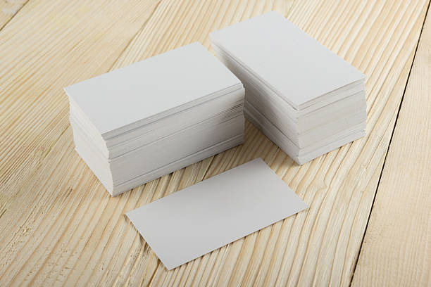 istock White blank business visit card, ticket, pass, present  wooden background 505412208