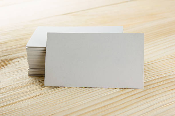 istock White blank business visit card, ticket, pass, present  wooden background 505412314