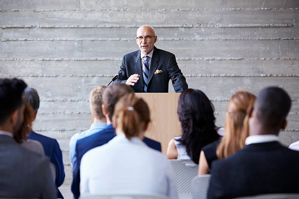 istock Senior Businessman Addressing Delegates At Conference 505413436