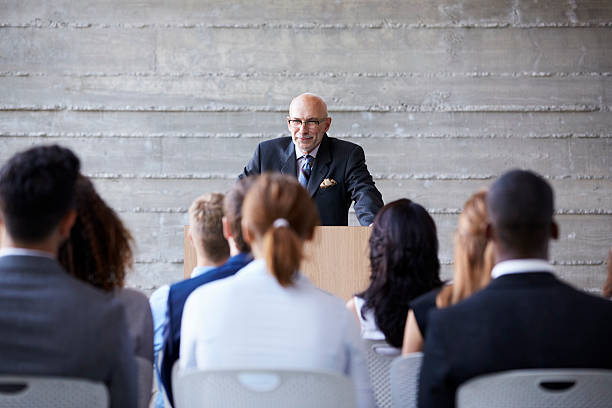istock Senior Businessman Addressing Delegates At Conference 505413610