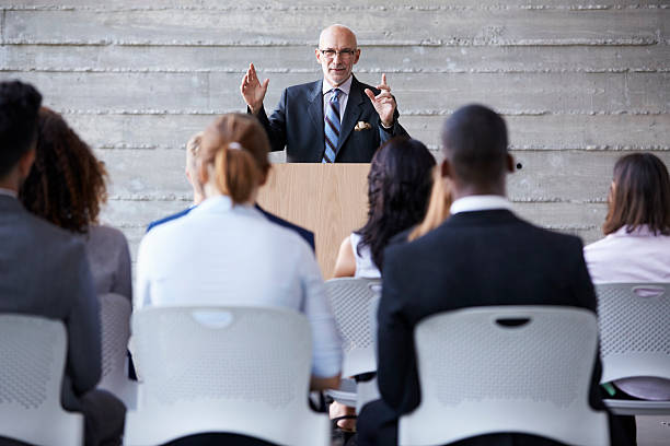 istock Senior Businessman Addressing Delegates At Conference 505413772