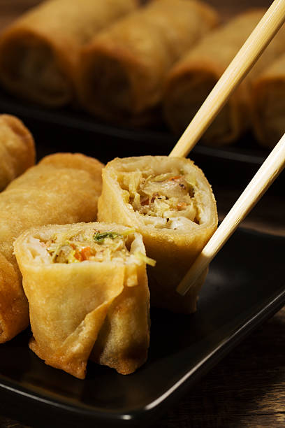 istock Baked spring rolls with vegetables on a black plate 505414846
