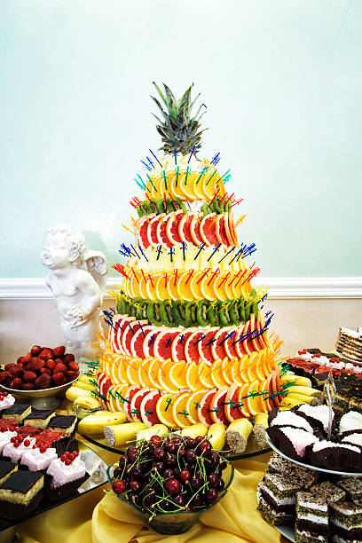 istock Fruit pyramid decoration, cakes and cookies at dessert table at 505414874