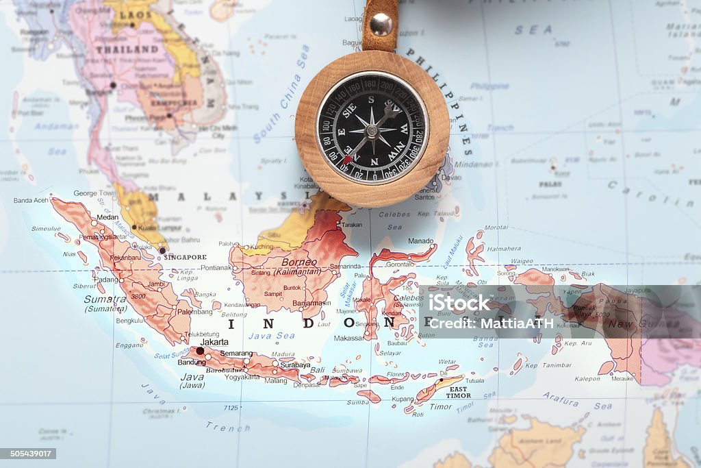 Travel destination Indonesia, map with compass Compass on a map pointing at Indonesia and planning a travel destination Arrow Symbol Stock Photo