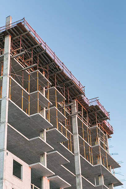 istock poured concrete construction and scaffolding blue sky 505441111