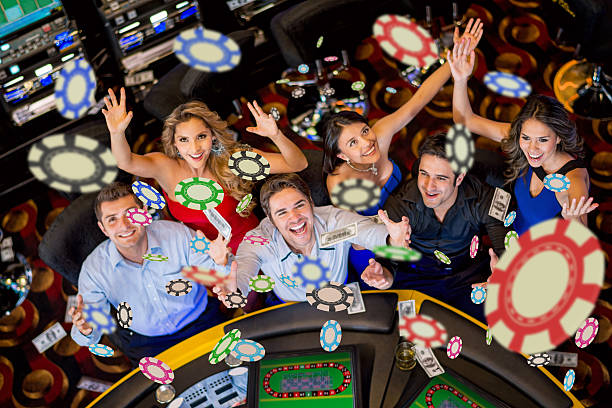 People winning at the casino Happy group of people winning at the casino casino stock pictures, royalty-free photos & images