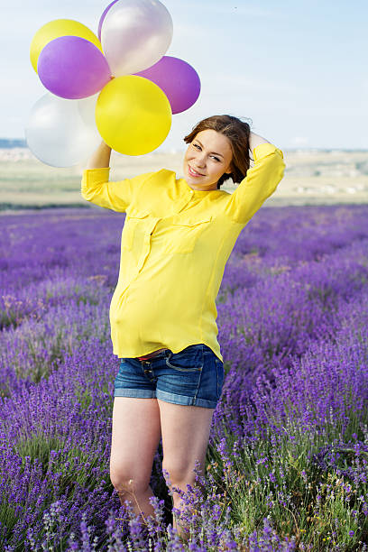 Beautiful pregnant woman in the lavender field stock photo
