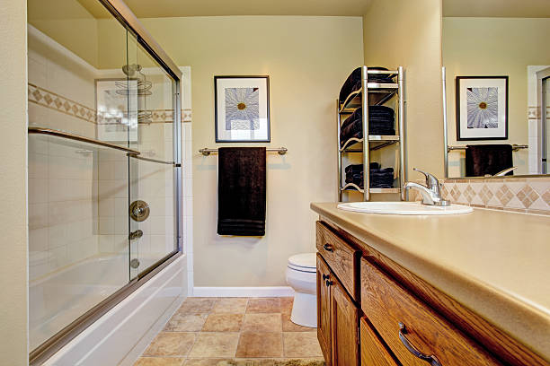 istock Bathroom wtih wooden vanity cabinet screened tub 505441533
