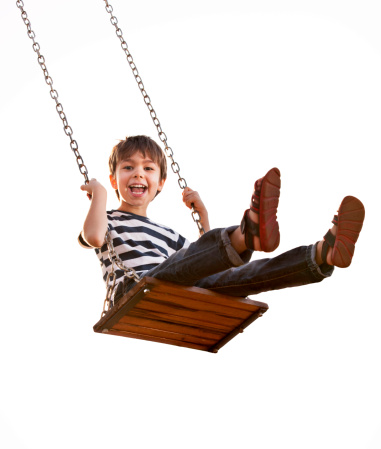 Preschool kid giggling and having fun on the playground of his daycare