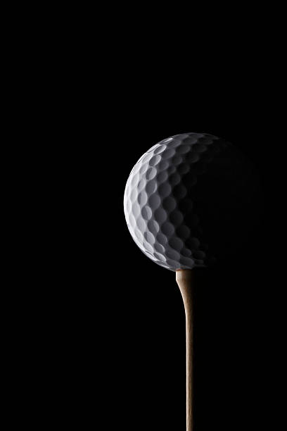 istock Golf ball on a tee, in dramatic black and white 505442167