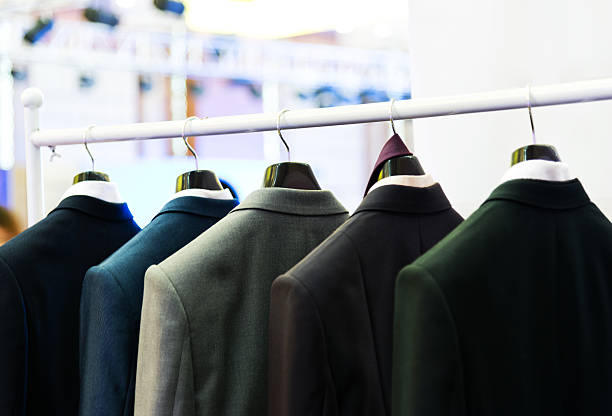 suits Row of men's suits hanging on the rack. garment store fashion rack stock pictures, royalty-free photos & images
