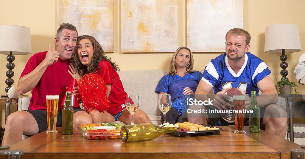 Football sports fans at home taunting each other 30-39 Years Stock Photo